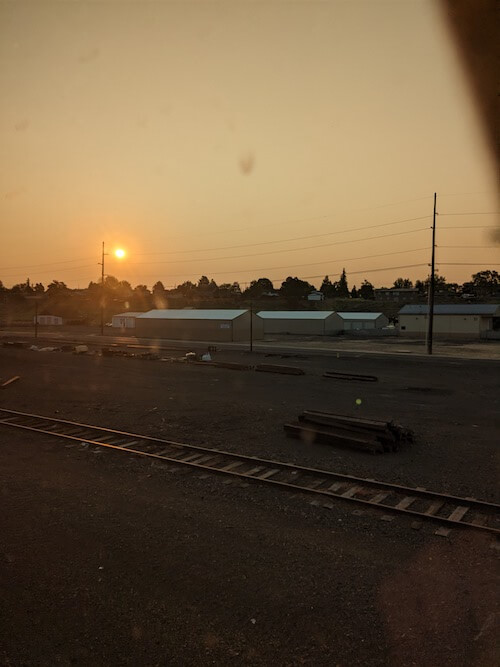 Red sun and smokey railway yard